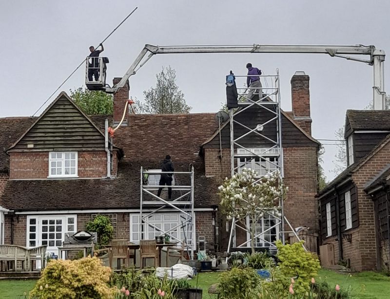 The Roof Moss Cleaners using cherry picker and scaffolding to clean roof safely and professionally in Bushey, Hertfordshire