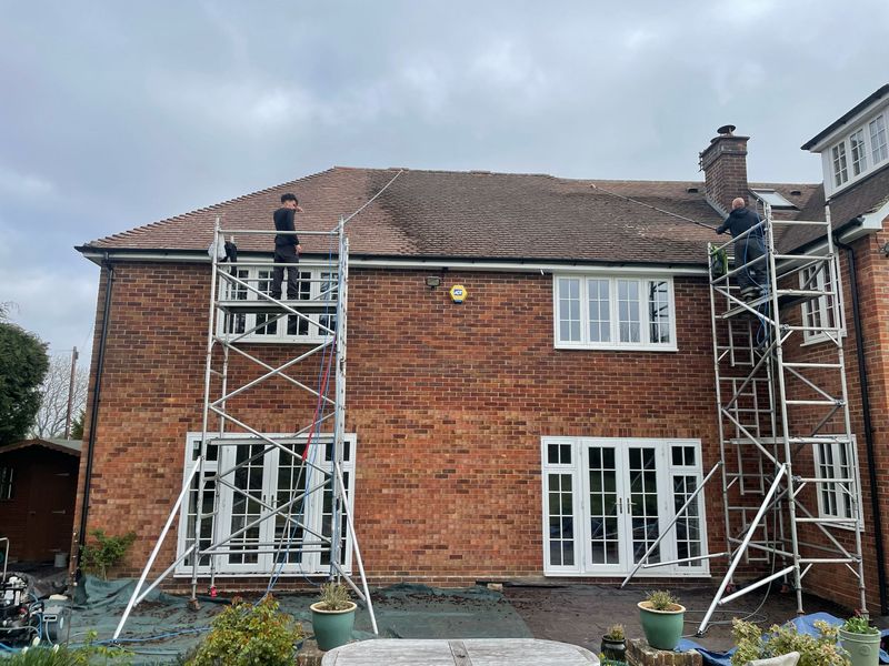 Roof cleaning carried out safely from scaffold towers by The Roof Moss Cleaners in Bushey